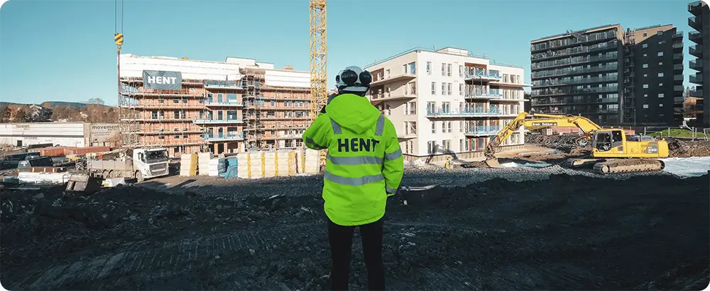 Hent worker in front of construction site