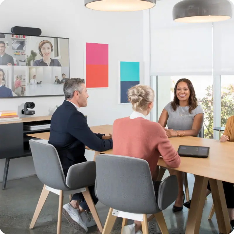 3 people video conferencing other team members presumably via Hybrid Workplace